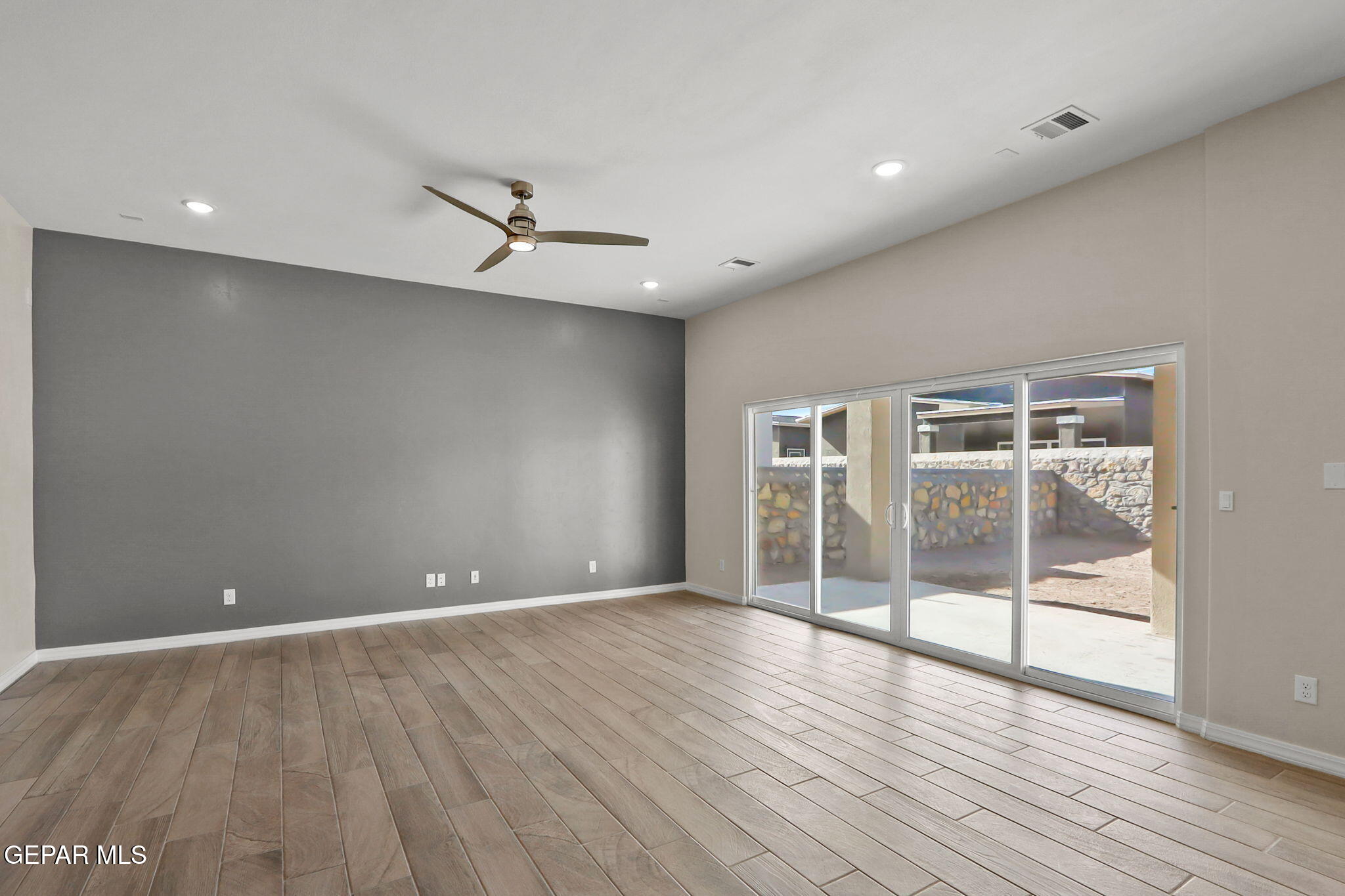 15313 Resolve Drive El Paso, TX 79938 - Photo 17 of 45 an empty room with wooden floor and windows