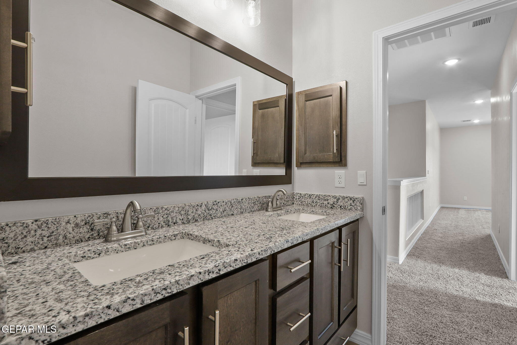 15313 Resolve Drive El Paso, TX 79938 - Photo 37 of 45 a bathroom with a granite countertop sink and a mirror