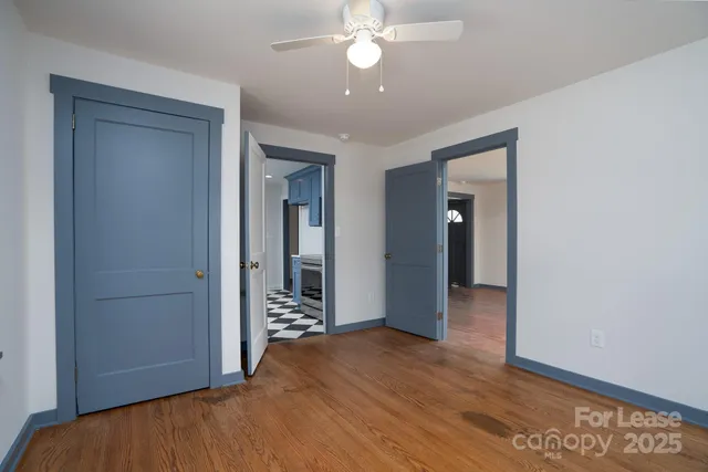 an empty room with wooden floor and closet
