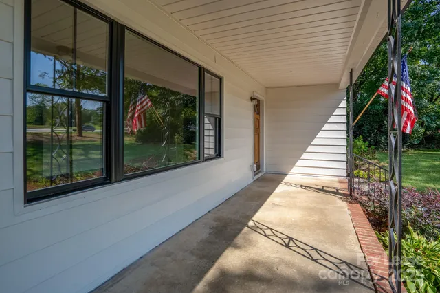 a balcony with couch and wooden floor