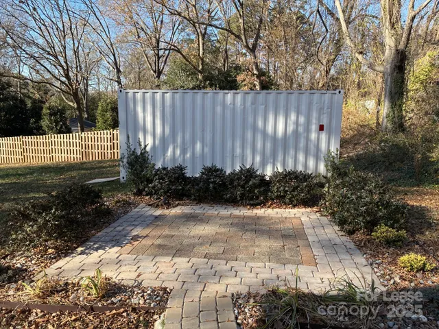 a view of a pathway covered with wooden fence