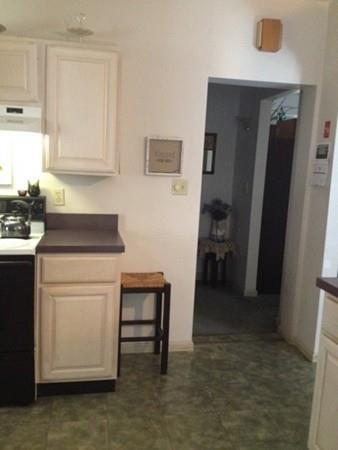 20 Spring Street Ware, MA 01082 - Photo 10 of 41 a kitchen with a refrigerator and white cabinets
