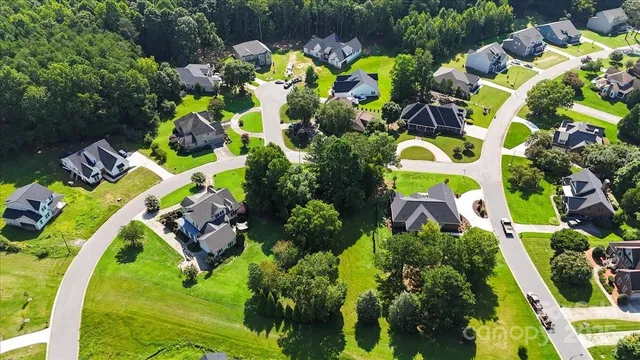 an aerial view of a residential houses with outdoor space and street view