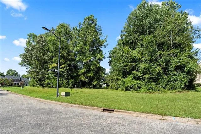 an aerial view of a pool a yard garage and outdoor seating
