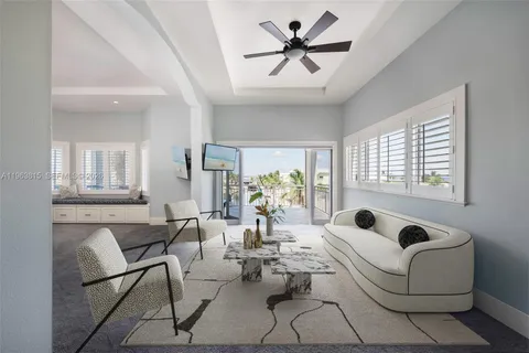 a living room with furniture couches and a large window
