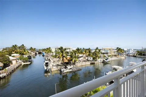 a bathroom with a double vanity sink toilet and a mirror