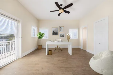 a spacious bedroom with a bed and a potted plant