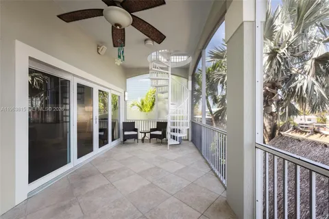 a view of a porch with a table and chairs