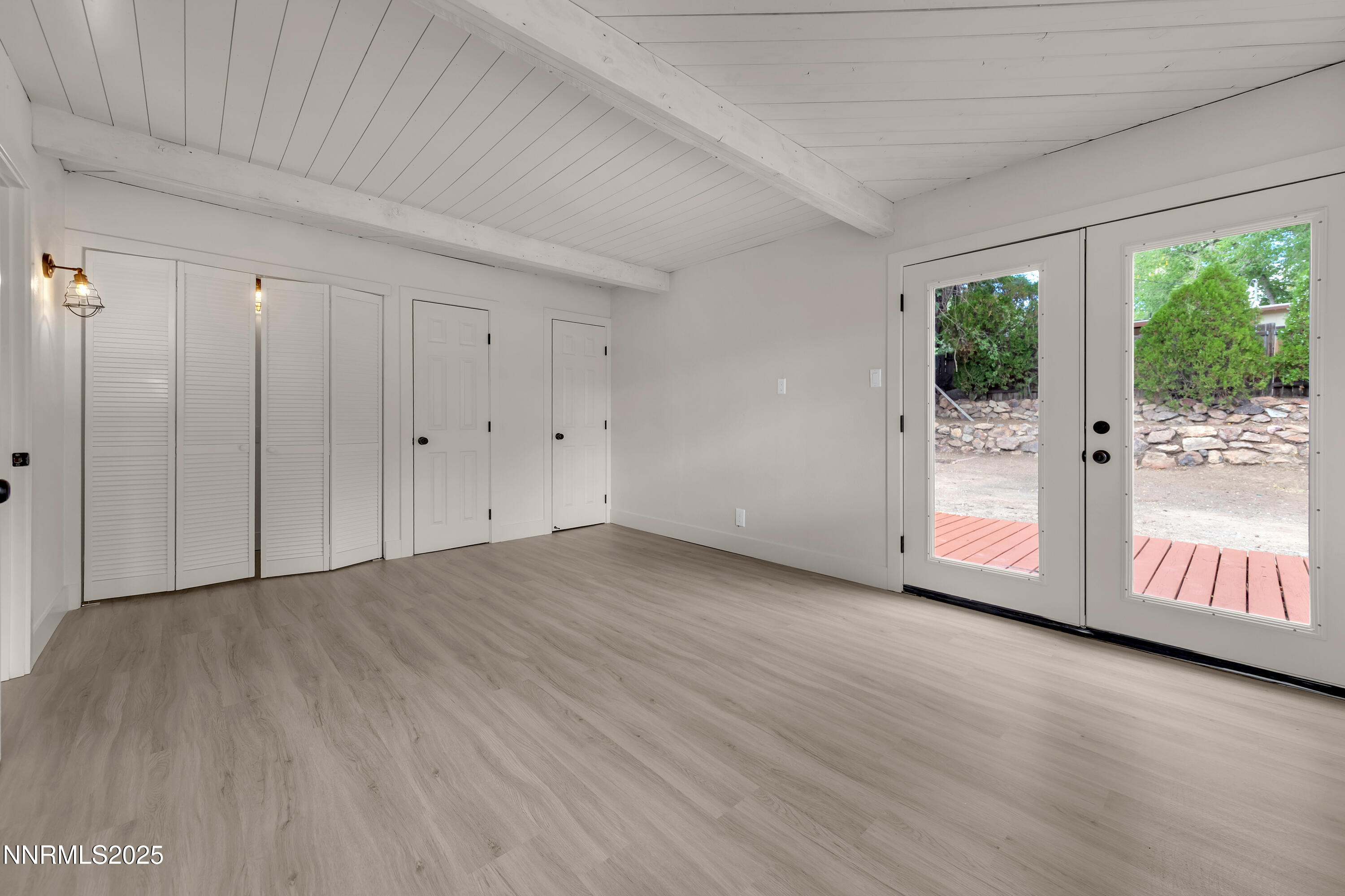 1725 Sterling Way Reno, NV 89512 - Photo 12 of 26 a view of an empty room with wooden floor and a window
