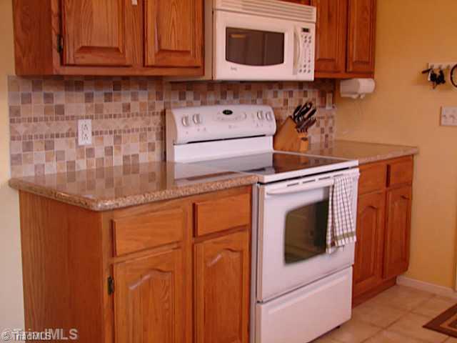 Kitchen. Granite countertops, smooth surface range, new cabinets, built-in microwave