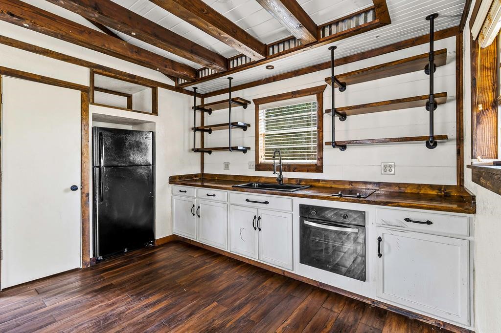 1542 Hillbilly Heaven Road Livingston, TX 77351 - Photo 24 of 27 a kitchen with stainless steel appliances granite countertop a stove and a refrigerator