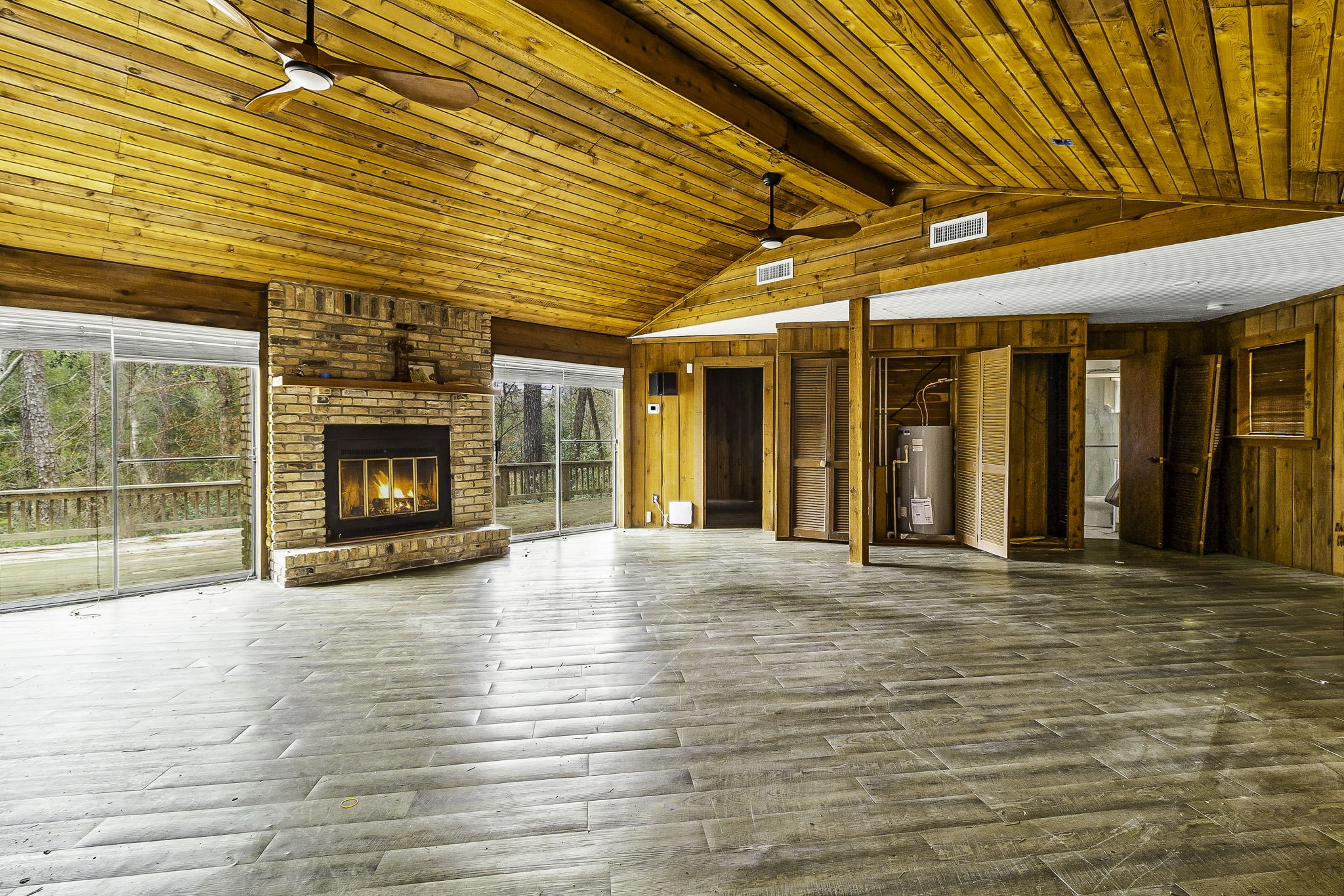 1542 Hillbilly Heaven Road Livingston, TX 77351 - Photo 3 of 27 a view of an empty room with wooden floor and a window