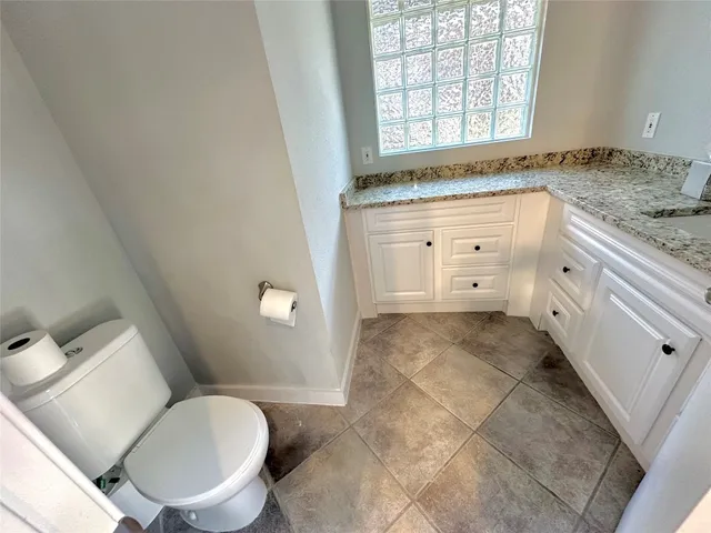 a bathroom with a granite countertop sink mirror and