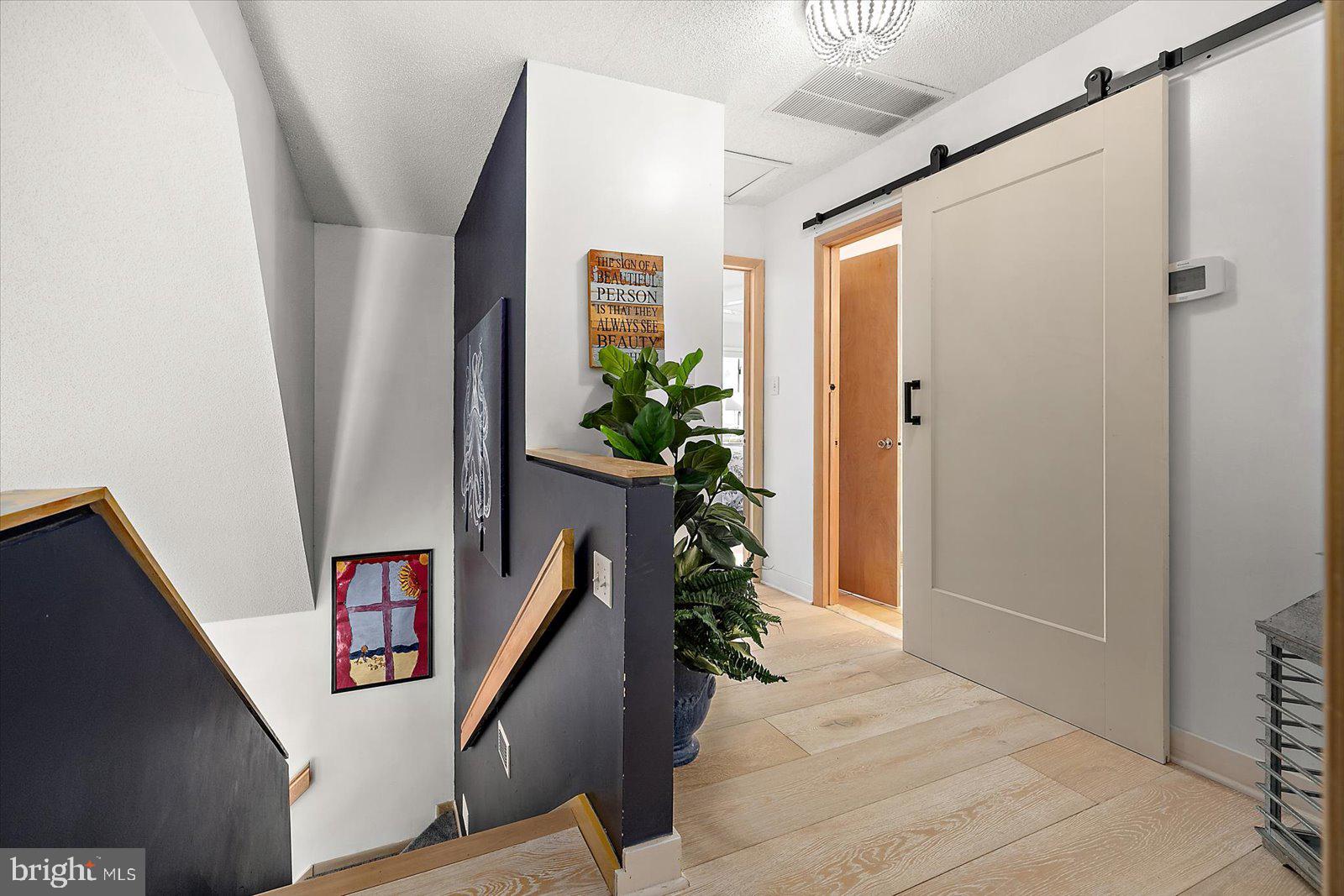 943 Pine Tree Lane Bethany Beach, DE 19930 - Photo 30 of 87 Landing with barn door to the bathroom