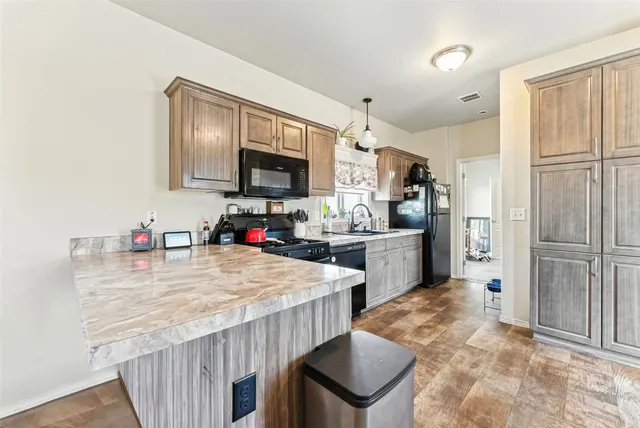 a kitchen with sink refrigerator and microwave