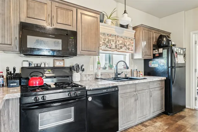 a kitchen with stainless steel appliances granite countertop a stove and a microwave