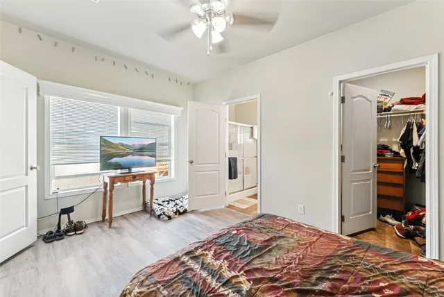 a bedroom with a bed and a chandelier