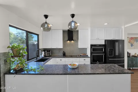 a large kitchen with furniture and a chandelier