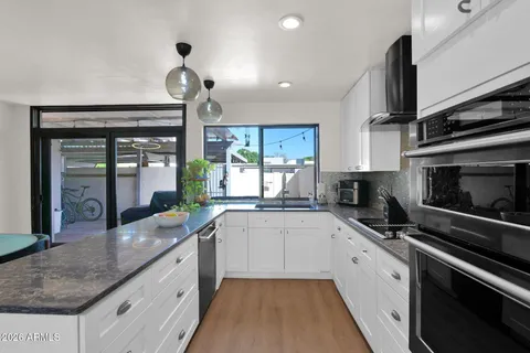 a kitchen with a refrigerator and a sink