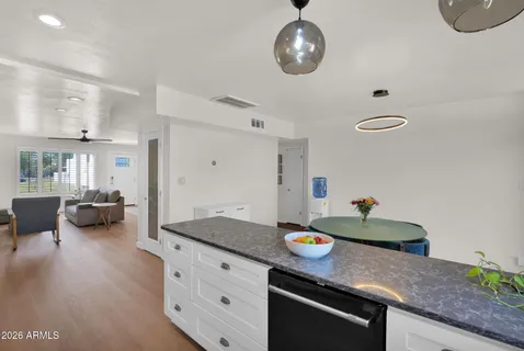 a kitchen with granite countertop a sink stainless steel appliances and cabinets