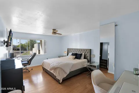 a bedroom with a bed and a chair