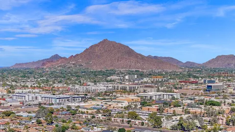 an aerial view of a house with outdoor space swimming pool and mountains