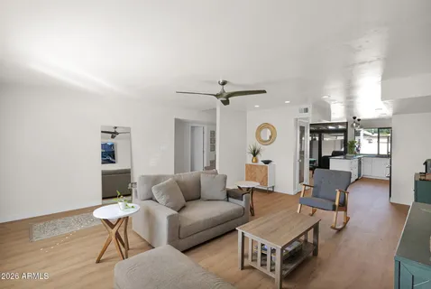 a living room with furniture and a wooden floor