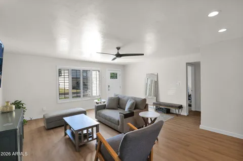 a living room with furniture and wooden floor