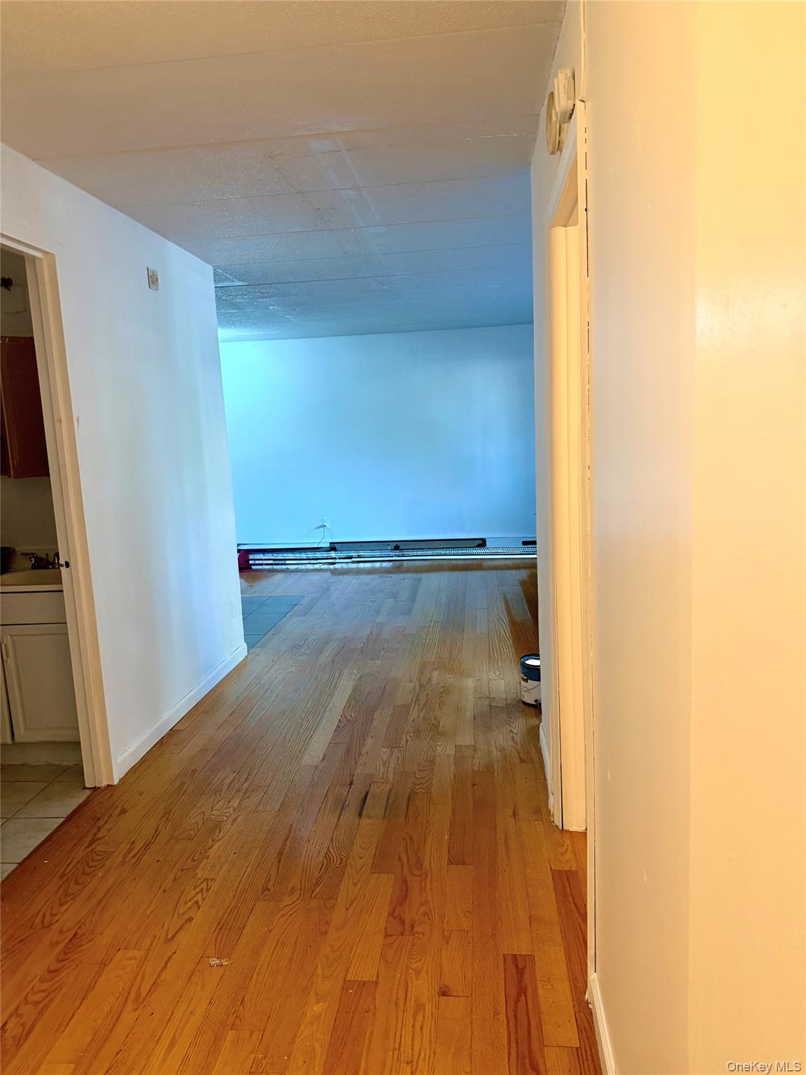 134-46 Maple Avenue, Unit 1C Queens, NY 11355 - Photo 6 of 12 a view of a room with wooden floor