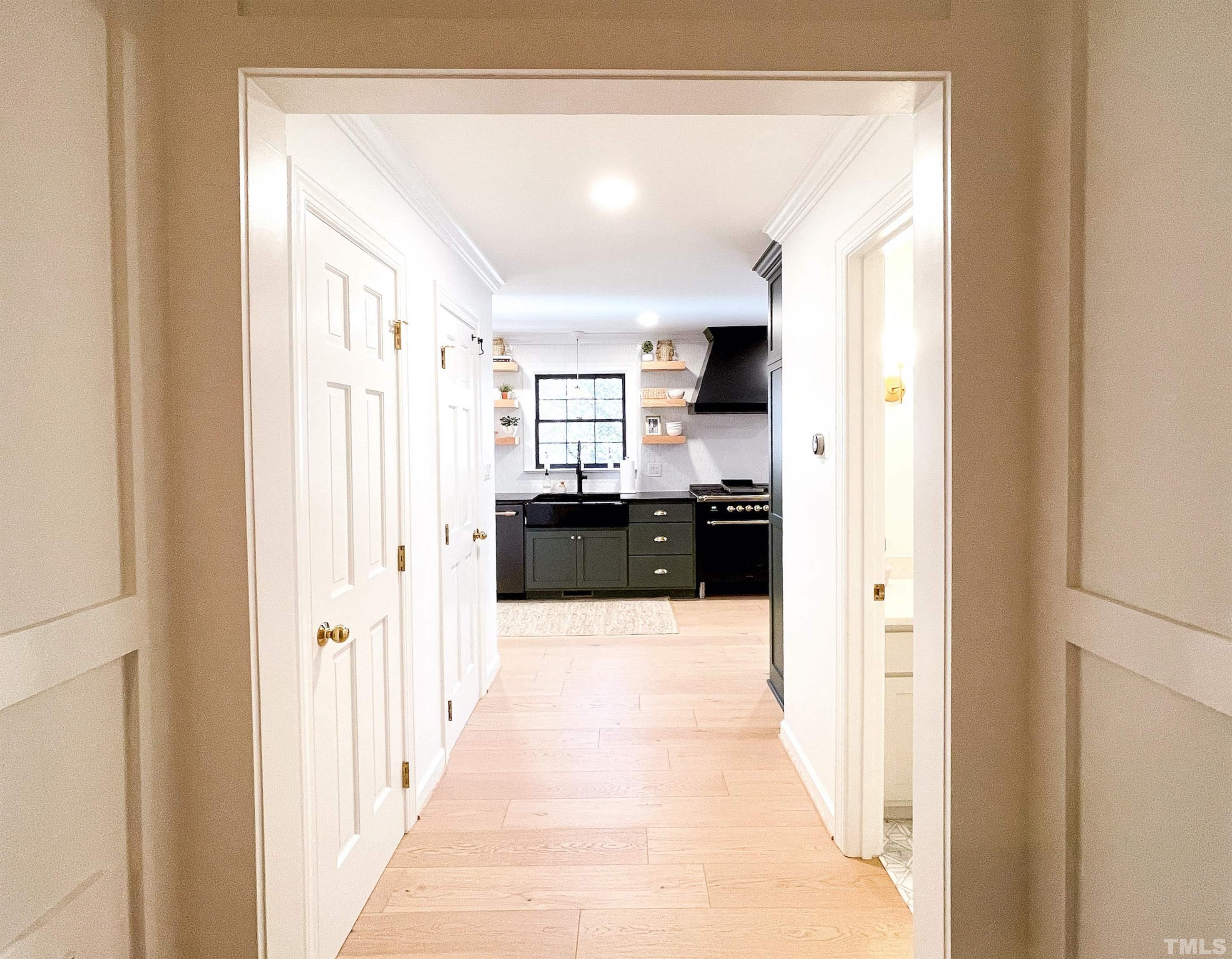 5025 Red Cedar Road Raleigh, NC 27613 - Photo 29 of 75 a large white kitchen with a sink and dishwasher a refrigerator with wooden floor