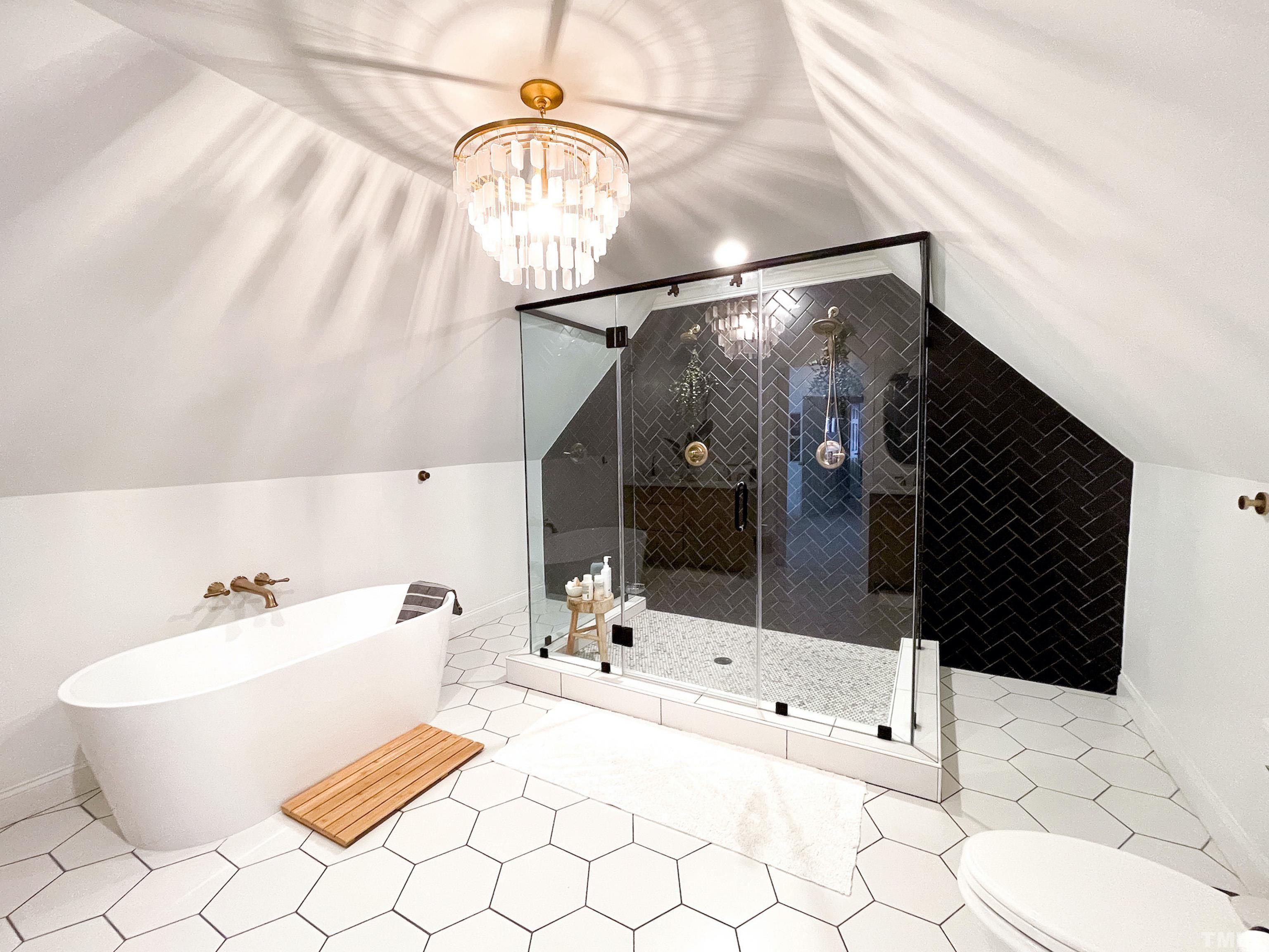 5025 Red Cedar Road Raleigh, NC 27613 - Photo 35 of 75 a bathroom with a bathtub and a shower