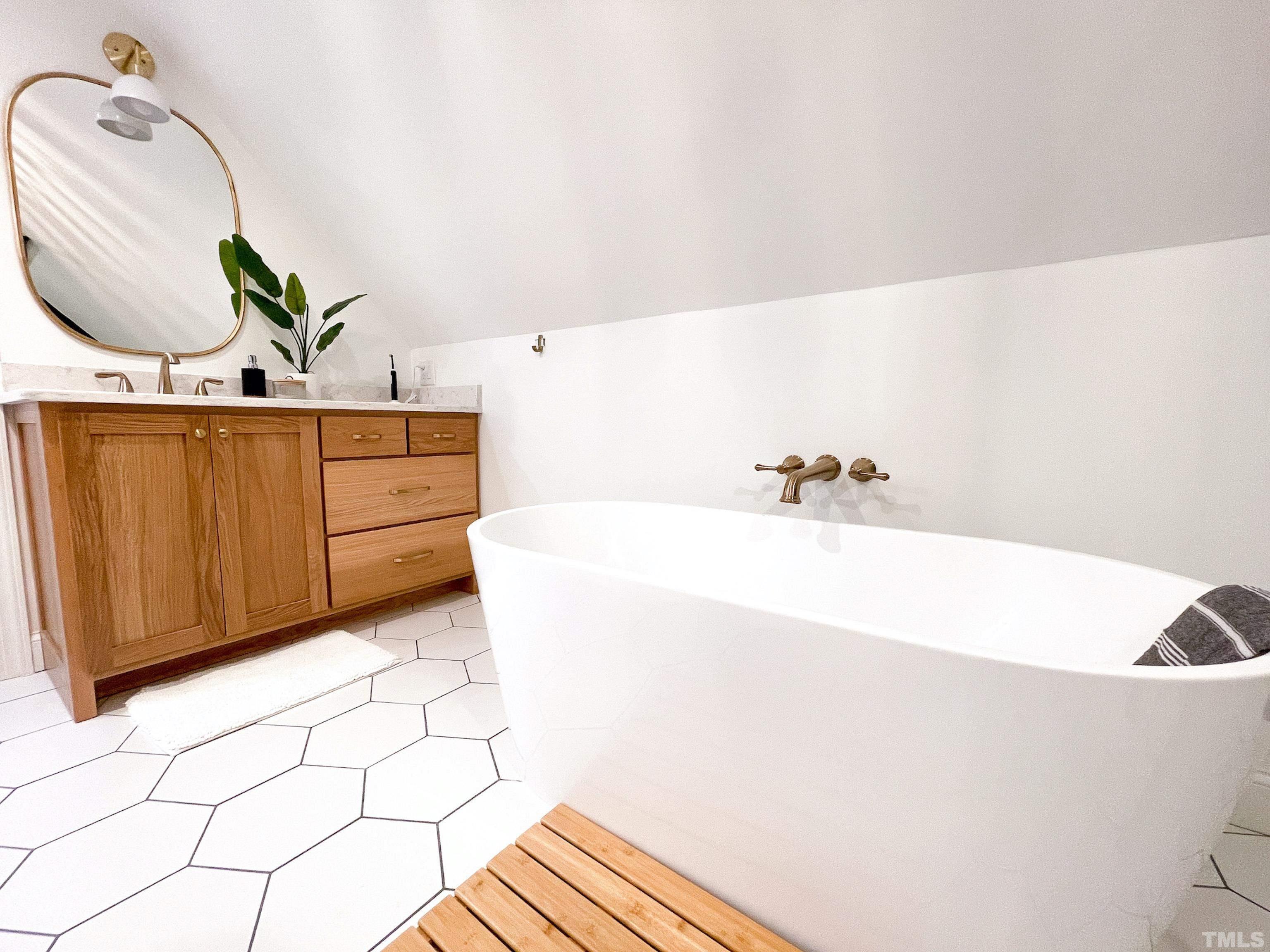 5025 Red Cedar Road Raleigh, NC 27613 - Photo 37 of 75 a bathroom with a bathtub and a sink