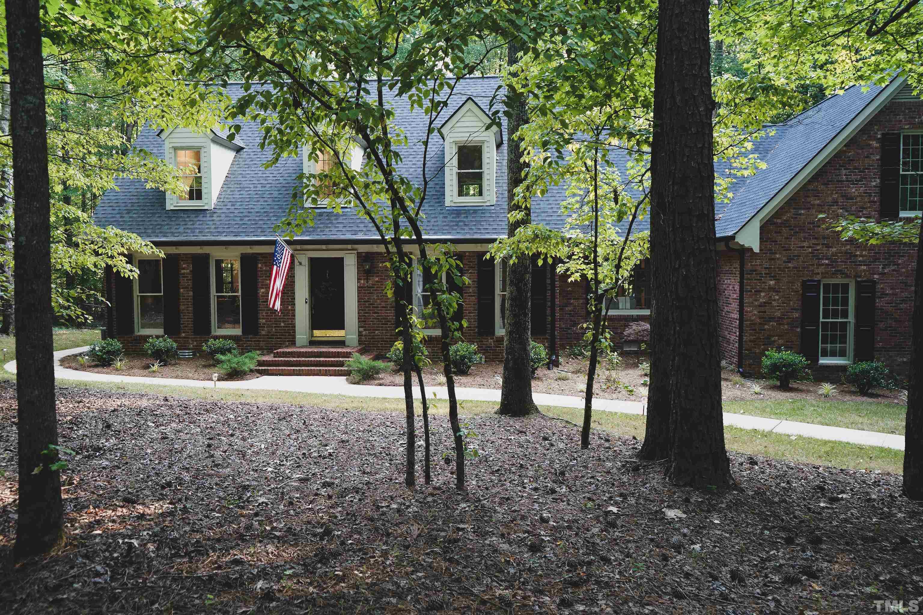 5025 Red Cedar Road Raleigh, NC 27613 - Photo 5 of 75 a front view of a house with garden