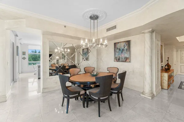 a view of a dining room with furniture and chandelier