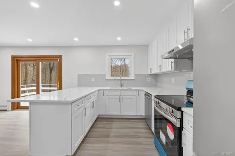 a kitchen with stainless steel appliances granite countertop a stove and a sink
