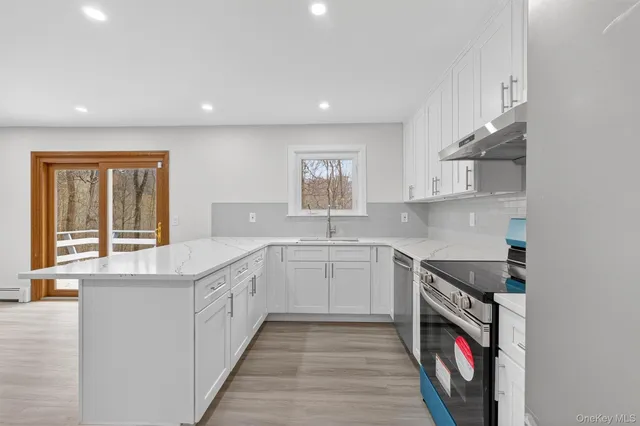 a kitchen with stainless steel appliances granite countertop a stove and a sink