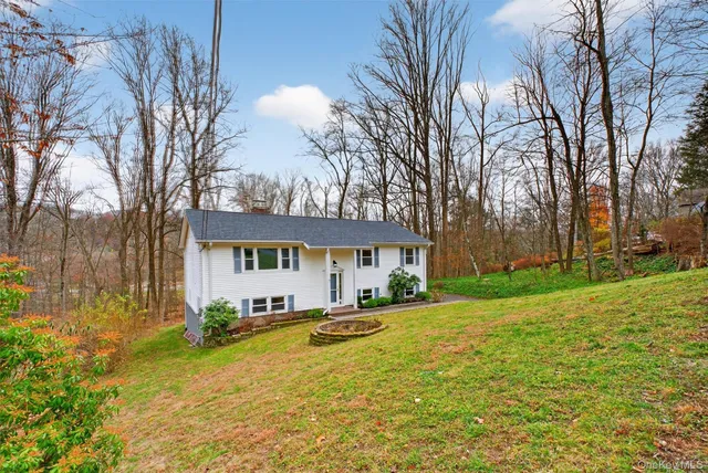 a view of a house with a yard covered in snow