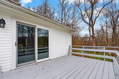 a view of backyard with deck and wooden floor