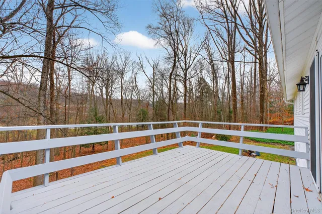 a view of a roof deck with couches and wooden floor