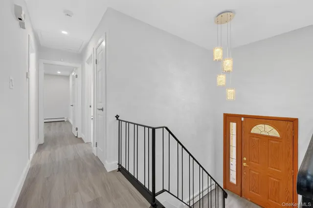 a view of a hallway with wooden floor and windows