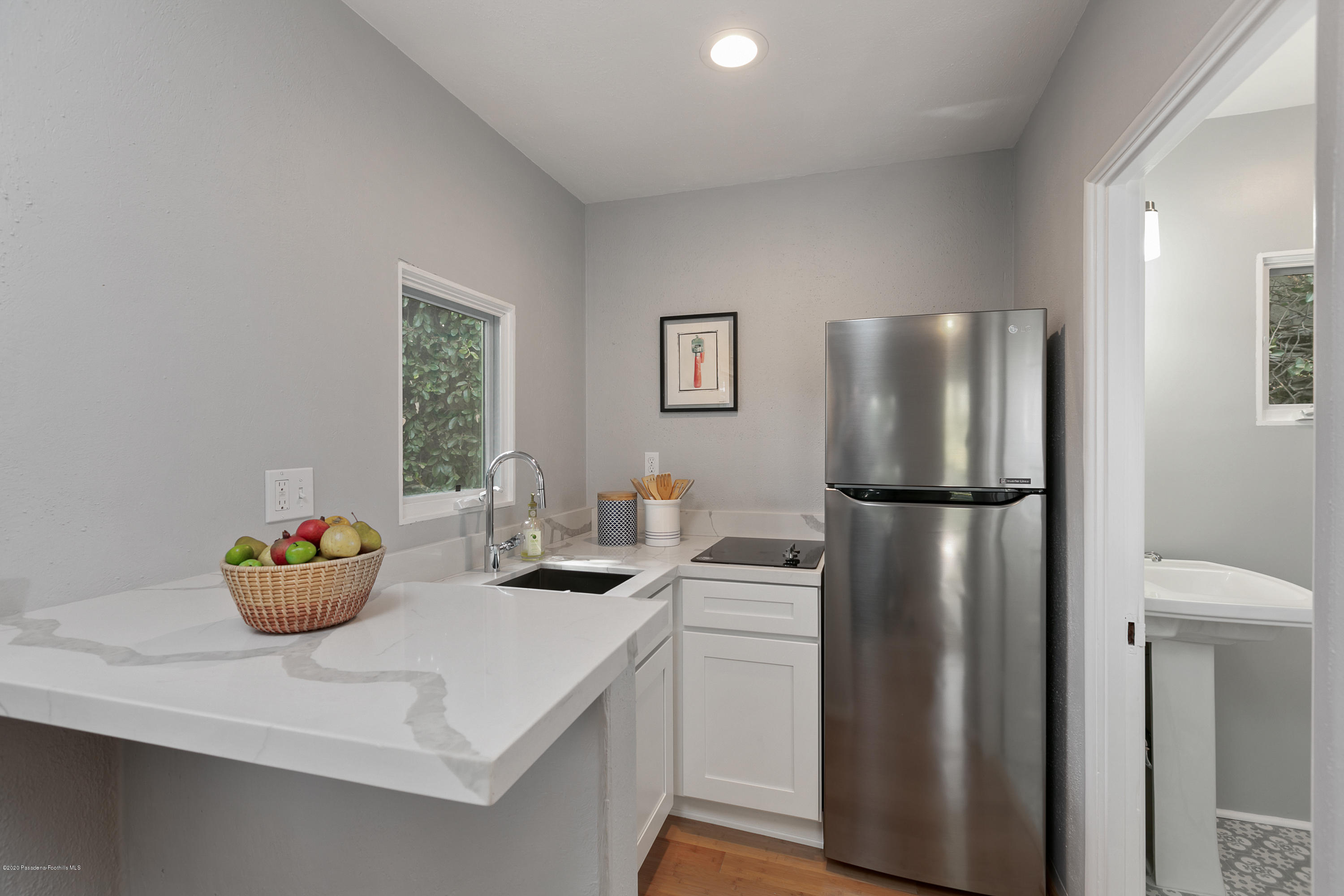 1691 Meadowbrook Road Altadena, CA 91001 - Photo 27 of 35 a kitchen with a refrigerator and white cabinets