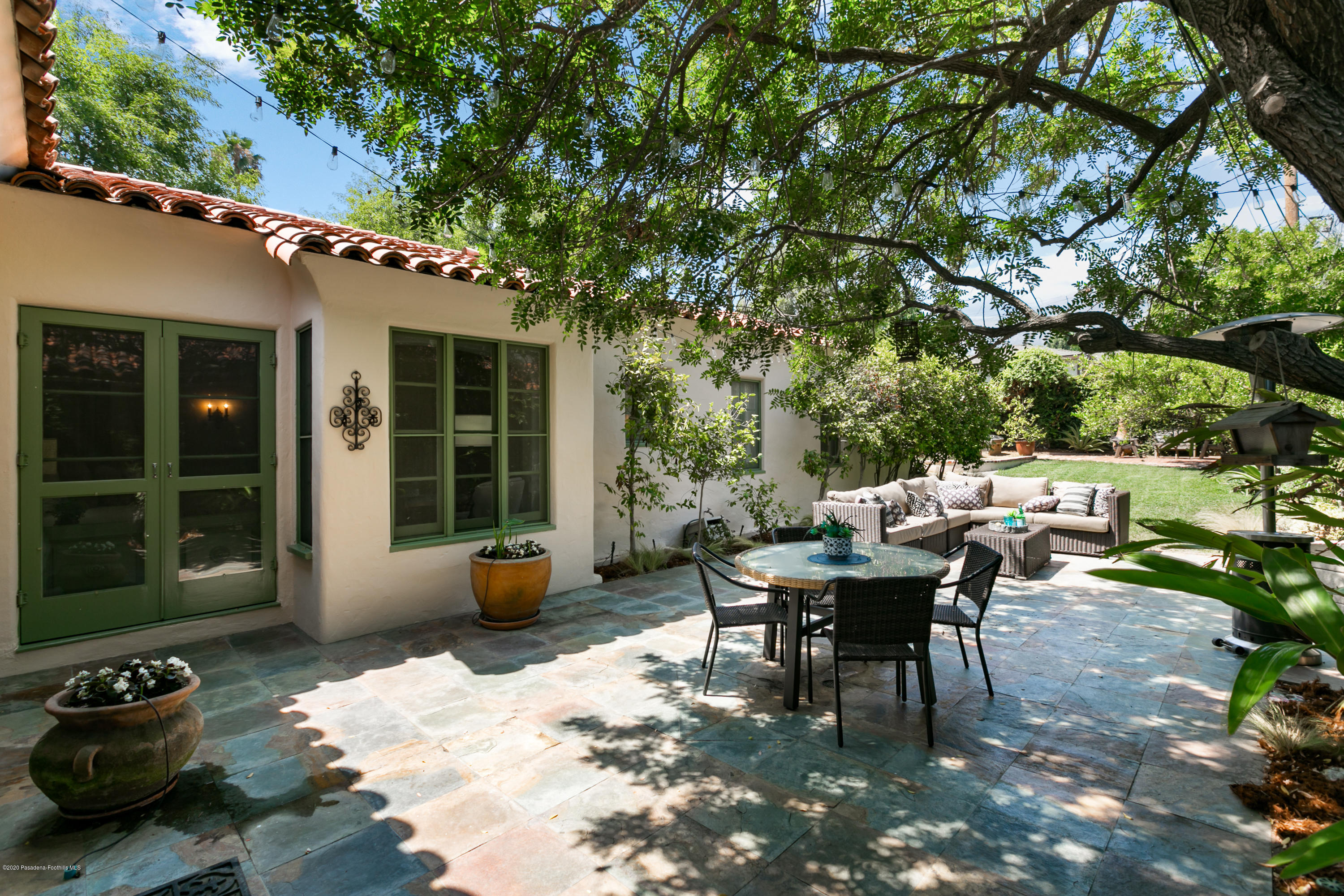 1691 Meadowbrook Road Altadena, CA 91001 - Photo 29 of 35 a view of a patio with table and chairs potted plants with large tree