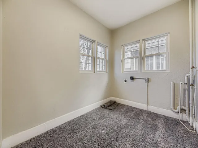 a room with a exposed radiator down to a window