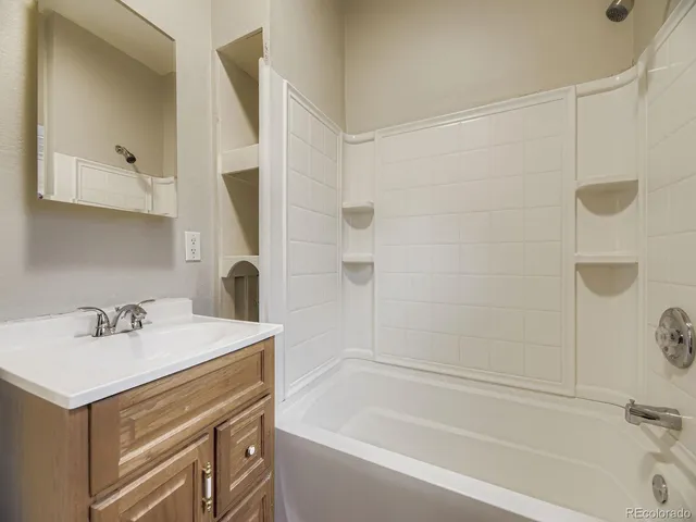 a bathroom with a sink a mirror and a bathtub