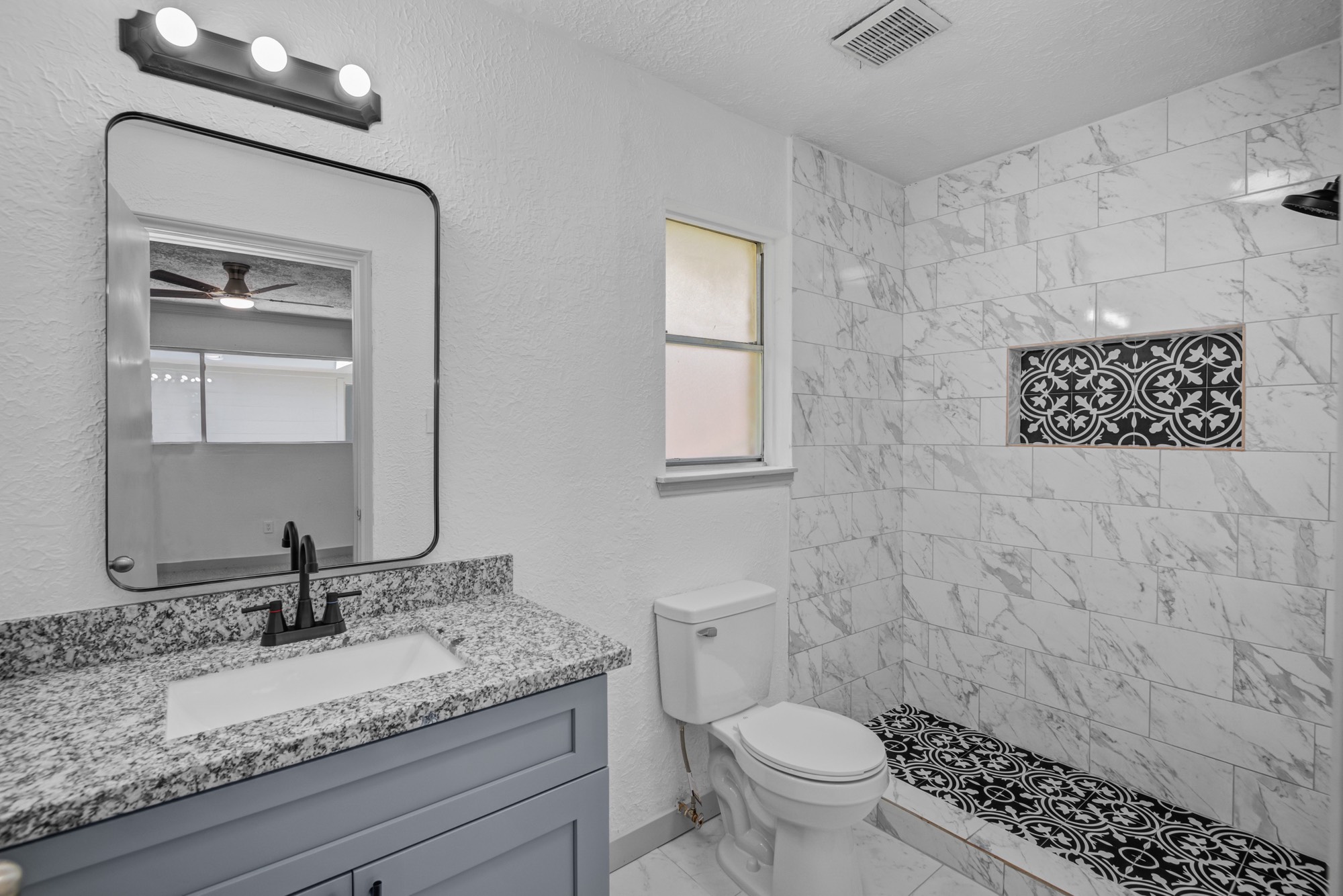 13747 Rampchester Lane Houston, TX 77015 - Photo 13 of 24 a bathroom with a granite countertop toilet a sink and a mirror