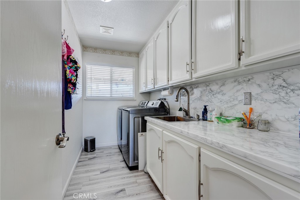 19783 Lara Lane Apple Valley, CA 92308 - Photo 17 of 42 a kitchen with a sink and cabinets