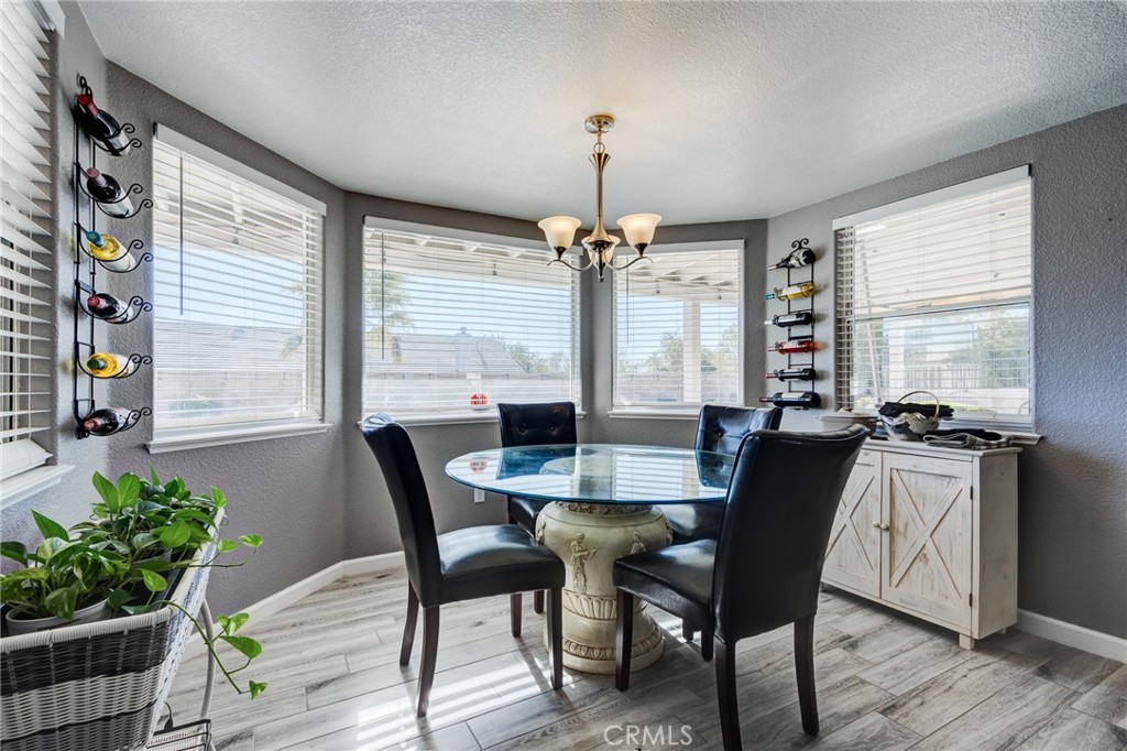 19783 Lara Lane Apple Valley, CA 92308 - Photo 18 of 42 a view of a dining room with furniture window and wooden floor