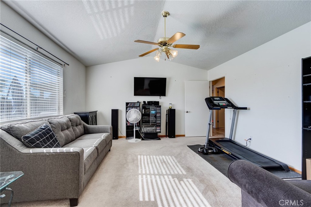 19783 Lara Lane Apple Valley, CA 92308 - Photo 22 of 42 a living room with furniture and a flat screen tv