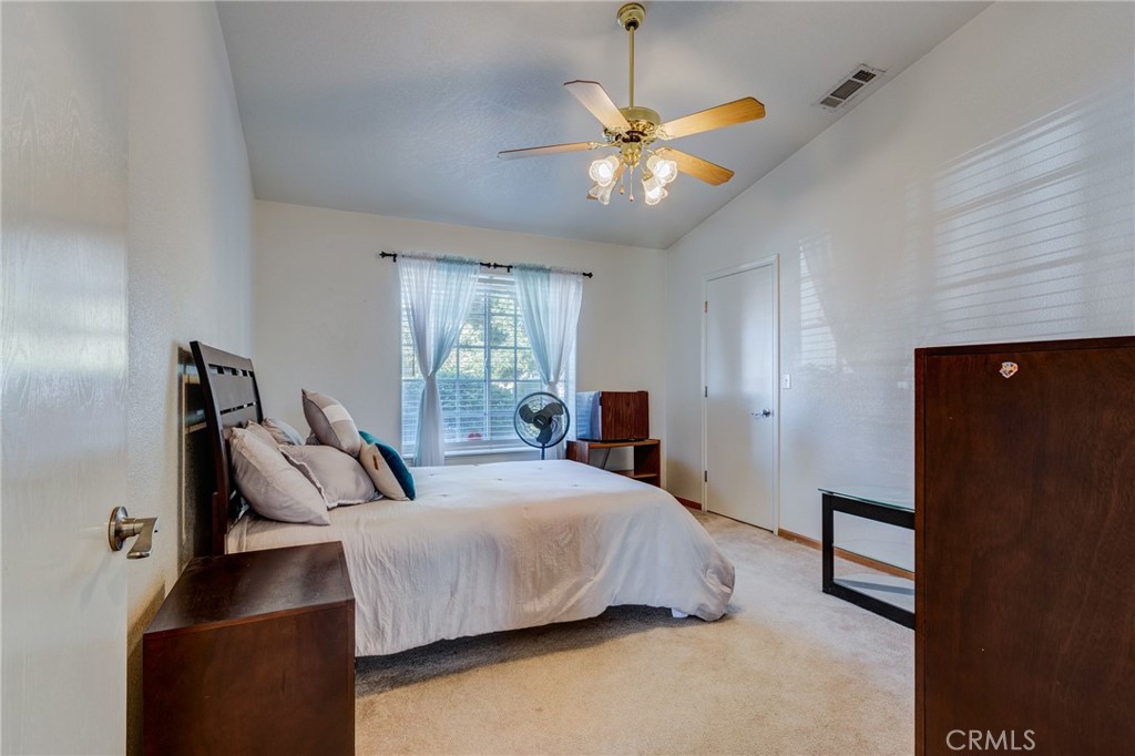 19783 Lara Lane Apple Valley, CA 92308 - Photo 23 of 42 a bedroom with a bed and a chandelier