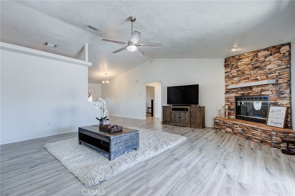 19783 Lara Lane Apple Valley, CA 92308 - Photo 29 of 42 a living room with furniture a flat screen tv and a fireplace